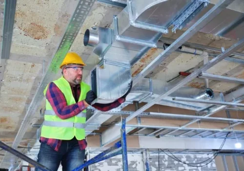 A commercial technician installing custom ventilation for a business in Springfield, IL