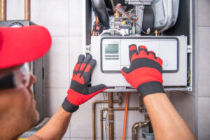 A technician from R.D. Davis Heating & Air Conditioning performs furnace repair in Chatham IL
