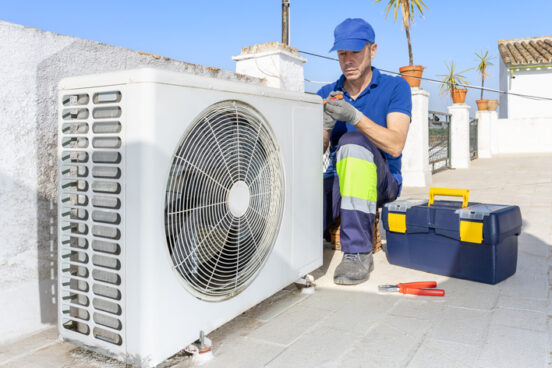 An HVAC technician performs air conditioner maintenance inspection as part of R.D. Davis Heating & Air Conditioning's air conditioning repair Chatham IL residents trust